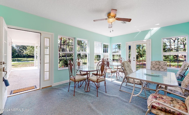 sunroom featuring ceiling fan