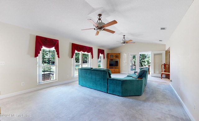 unfurnished living room featuring ceiling fan, lofted ceiling, and light carpet