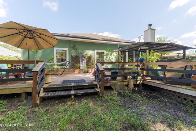 rear view of house featuring a deck