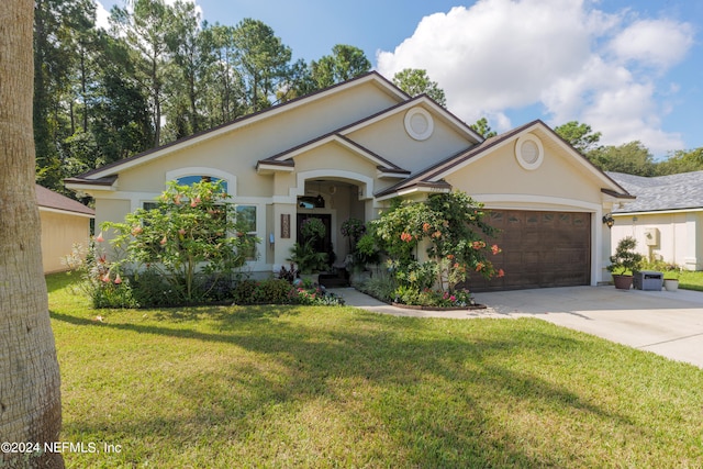 single story home with a garage and a front lawn