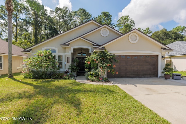 view of front of house with a front yard and a garage