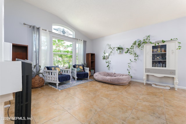 living room with vaulted ceiling and light tile patterned floors