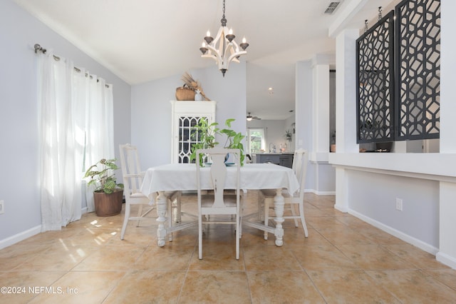 dining space featuring a notable chandelier, lofted ceiling, and light tile patterned floors