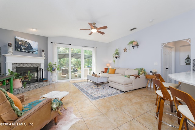 living room with ceiling fan, light tile patterned flooring, and a fireplace