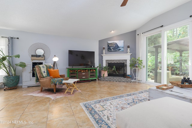 tiled living room featuring lofted ceiling and ceiling fan