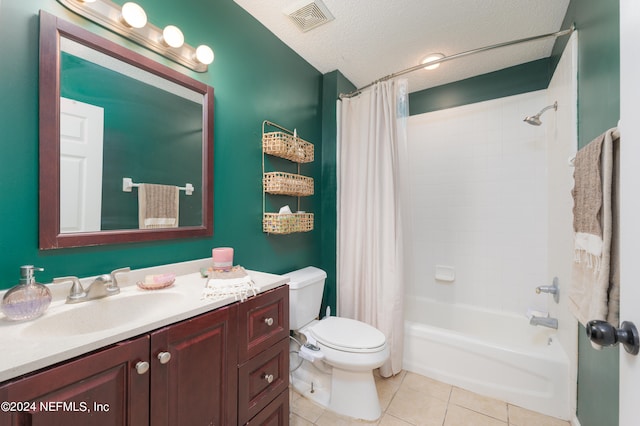 full bathroom with tile patterned flooring, a textured ceiling, shower / tub combo, vanity, and toilet