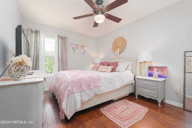 bedroom with ceiling fan and dark hardwood / wood-style flooring