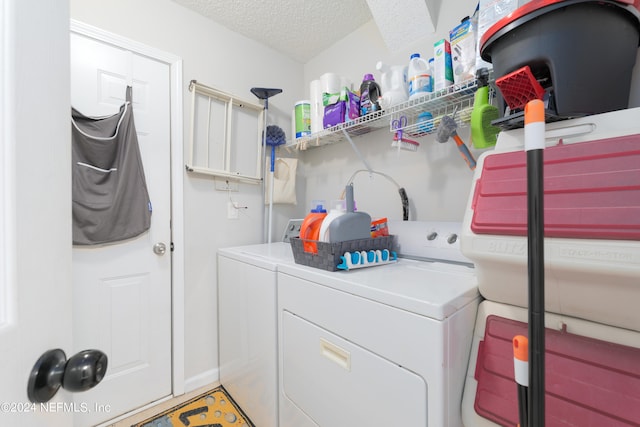 laundry room featuring a textured ceiling and washing machine and clothes dryer