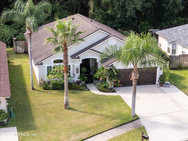 view of front of property with a garage and a front lawn