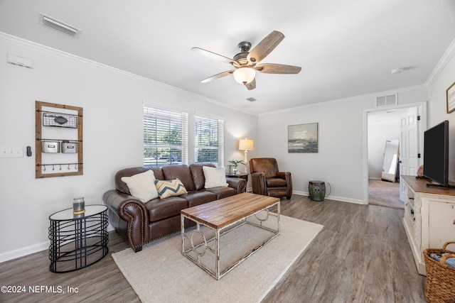 living room with light hardwood / wood-style floors, ceiling fan, and crown molding