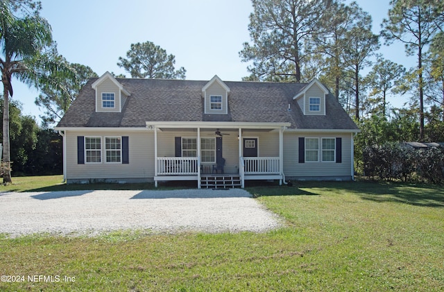 cape cod house featuring covered porch and a front yard