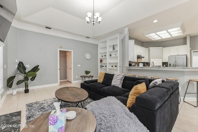 tiled living room with sink, built in features, and a chandelier