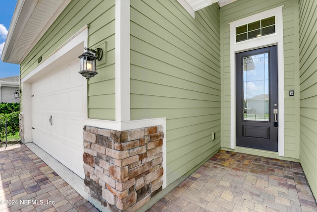 doorway to property featuring a garage