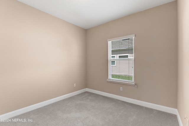 empty room featuring light colored carpet