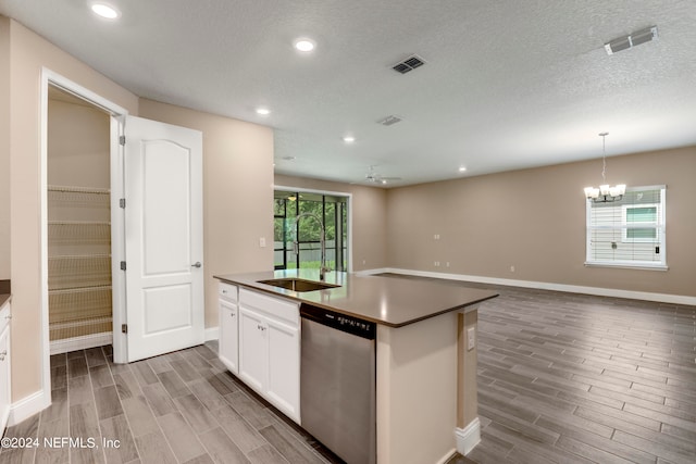 kitchen featuring white cabinetry, dishwasher, an island with sink, and wood-type flooring