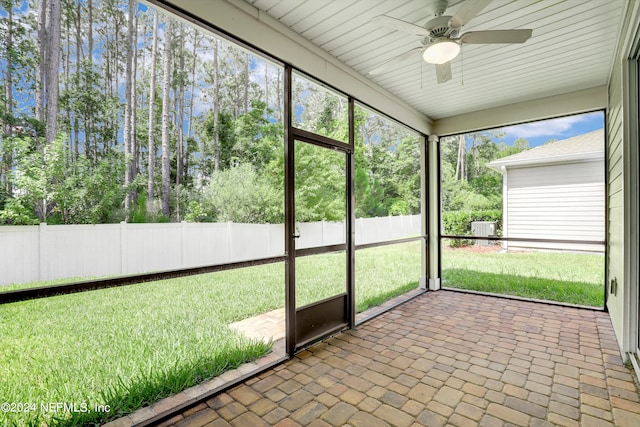 unfurnished sunroom with ceiling fan