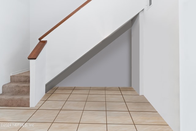 stairway with tile patterned floors