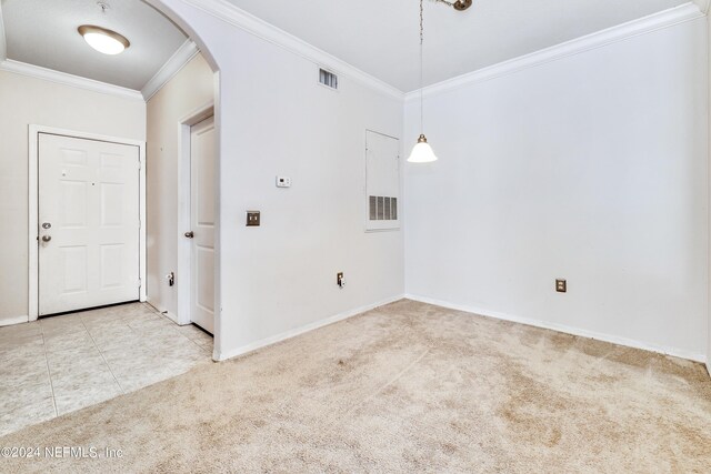 carpeted empty room featuring crown molding