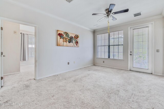 carpeted spare room featuring ornamental molding and ceiling fan