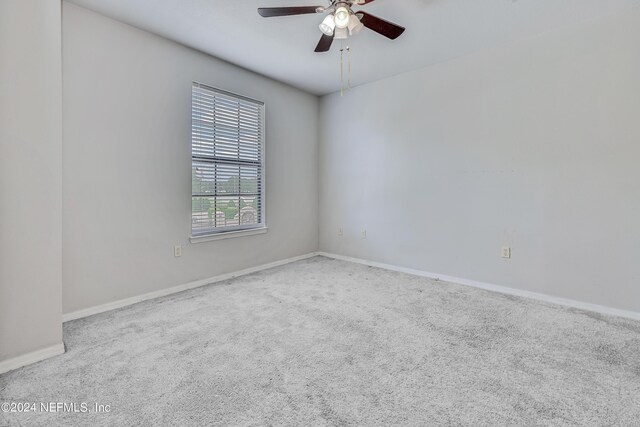 carpeted empty room with ceiling fan