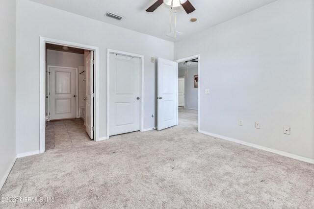 unfurnished bedroom with light carpet and ceiling fan