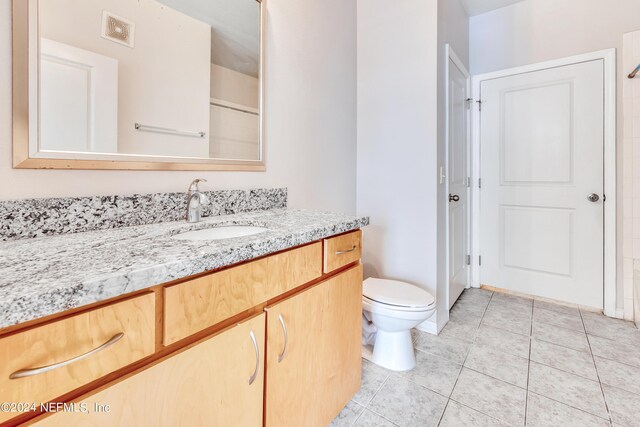 bathroom with tile patterned floors, toilet, and vanity