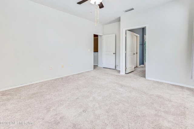 spare room featuring light carpet and ceiling fan