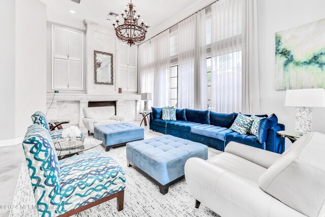 living room featuring a high end fireplace and a notable chandelier