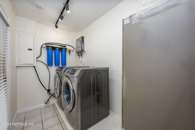 laundry room featuring independent washer and dryer, light tile patterned flooring, electric panel, and track lighting