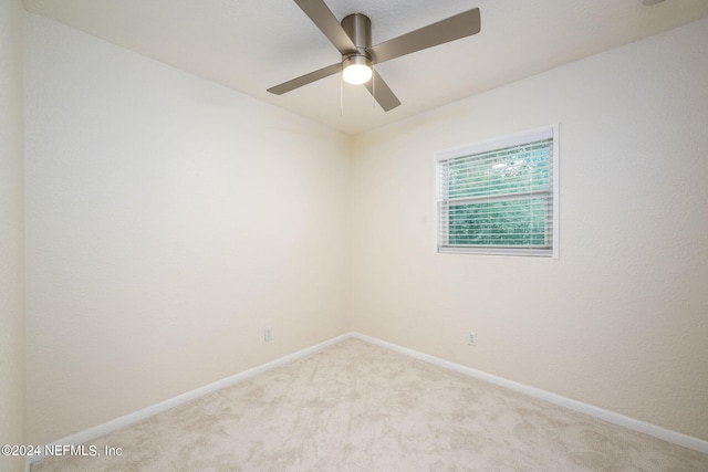 empty room featuring light carpet and ceiling fan