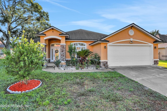 view of front of home featuring a garage and a front lawn