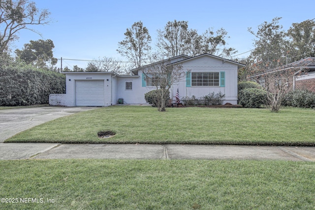 view of front of property featuring a garage, concrete driveway, and a front lawn