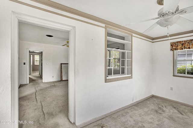 interior space featuring ceiling fan, ornamental molding, and baseboards