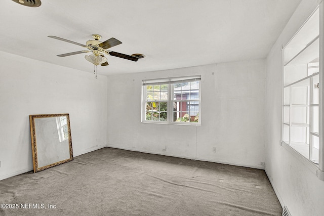 spare room featuring carpet floors and a ceiling fan