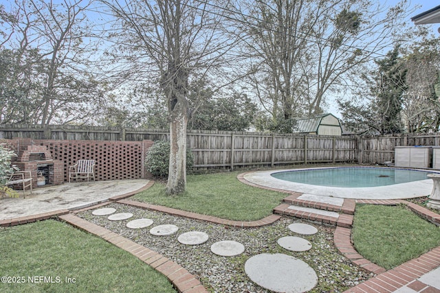 view of yard featuring a fenced backyard, a fenced in pool, and a patio