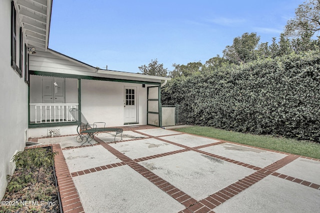 view of patio with a gate and fence