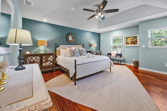 bedroom with vaulted ceiling, ceiling fan, and dark wood-type flooring