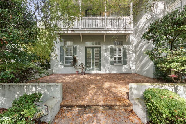 doorway to property featuring a balcony and a patio