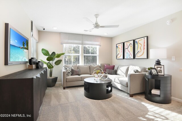 carpeted living room featuring ceiling fan