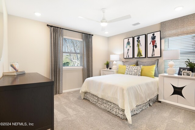 bedroom with ceiling fan and light colored carpet