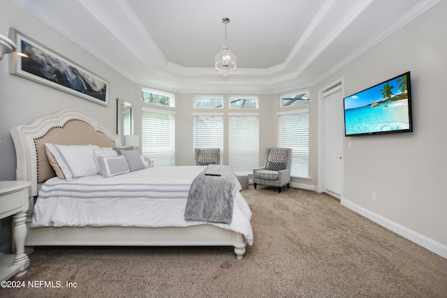 carpeted bedroom featuring a raised ceiling and crown molding