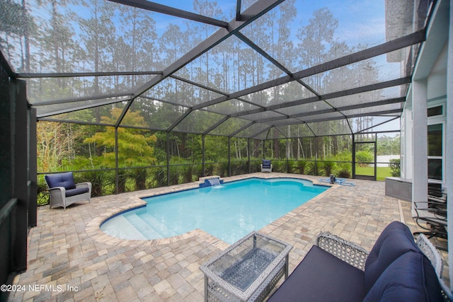 view of pool featuring a lanai, a patio, and an outdoor living space