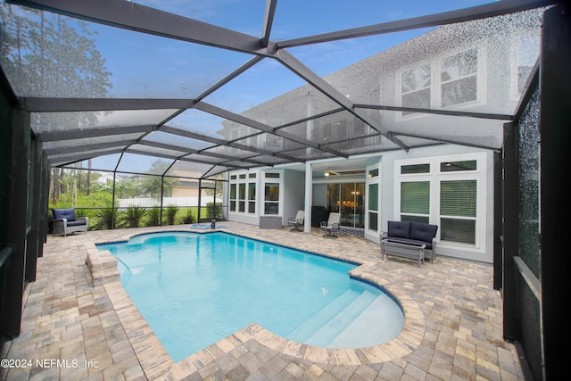 view of swimming pool with a lanai and a patio area