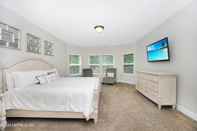 bedroom featuring light carpet