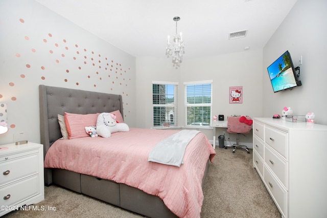 bedroom with an inviting chandelier and light colored carpet