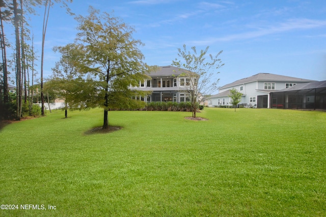 view of yard with glass enclosure