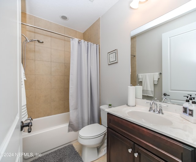 full bathroom featuring shower / bath combination with curtain, tile patterned flooring, vanity, and toilet