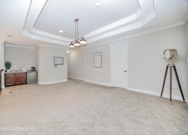 unfurnished living room featuring wine cooler, a raised ceiling, and light colored carpet