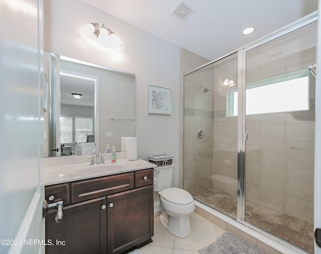 bathroom featuring tile patterned floors, walk in shower, vanity, and toilet