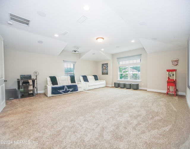 unfurnished living room with a wealth of natural light and carpet flooring